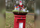 Britain’s iconic red mailboxes get holiday decorations