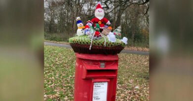 Britain’s iconic red mailboxes get holiday decorations